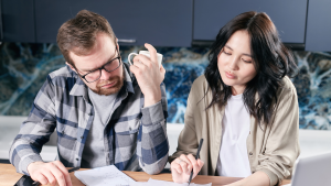 couple looking at papers representing learning about required minimum distributions (RMDS)